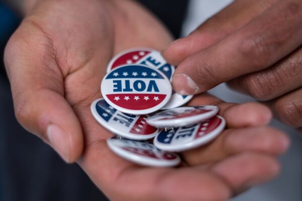 hands with vote pins